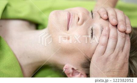 Caucasian woman receiving manual facial massage.  122382052