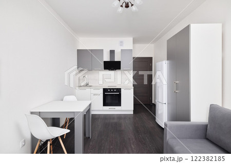 This is a Modern Minimalist Kitchen and Living Area designed in refined Neutral Tones 122382185