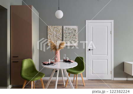 An Elegant and Stylish Dining Space Featuring Contemporary Decor with Vibrant Green Chairs An Elegant and Stylish Dining Space Featuring Contemporary Decor with Vibrant Green Chairs 122382224