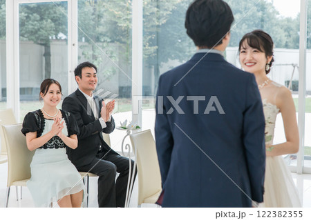 結婚式で拍手をして祝う笑顔のゲスト・出席者・参列者・友人の男女 122382355