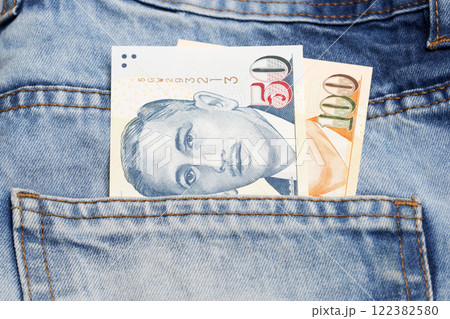Singapore dollar in the pocket of blue jeans Singapore dollar in the pocket of blue jeans 122382580
