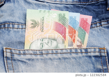 Indonesian rupiah in the pocket of blue jeans Indonesian rupiah in the pocket of blue jeans 122382584
