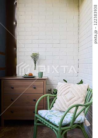 A Chic and Inviting Indoor Corner Featuring a Stylish Green Chair and Modern Decor Elements A Chic and Inviting Indoor Corner Featuring a Stylish Green Chair and Modern Decor Elements 122383938