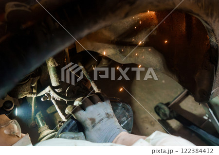 Mechanical Precision: A Close-Up of Automotive Welding in Action 122384412