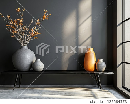 Minimalist arrangement of ceramic vases on a dark shelf 122384578