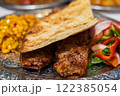 Grilled Turkish Adana, Urfa Kebab with grilled vegetables, onion and rice on plate. Adana durum. High quality photo 122385054