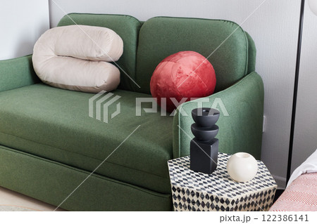 Stylish Green Couch with Beautiful Decorative Pillows in a Modern Living Room Setting 122386141