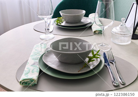 An Elegant Dining Table Setting with Beautiful and Sophisticated Tableware for Guests An Elegant Dining Table Setting with Beautiful and Sophisticated Tableware for Guests 122386150