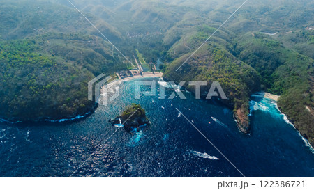 Aerial view of Nusa Penida island and ocean with Crystal bay beach. Coastal landscape with green hills and ocean Aerial view of Nusa Penida island and ocean with Crystal bay beach. Coastal landscape with green hills and ocean 122386721
