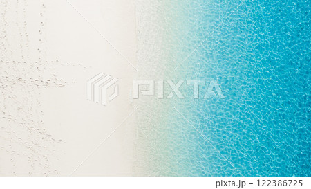 Tropical beach with white sand, turquoise sea water, aerial view. Top view of paradise beach in tropics with blue clear sea Tropical beach with white sand, turquoise sea water, aerial view. Top view of paradise beach in tropics with blue clear sea 122386725