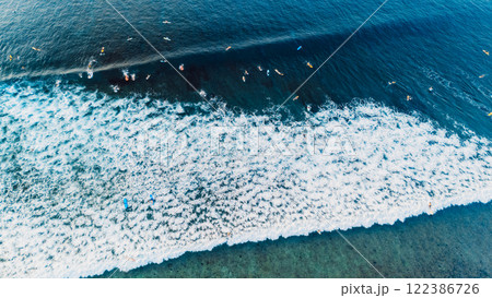 Aerial view of a lot of surfers during surfing on waves. Waves with surfers in ocean Aerial view of a lot of surfers during surfing on waves. Waves with surfers in ocean 122386726