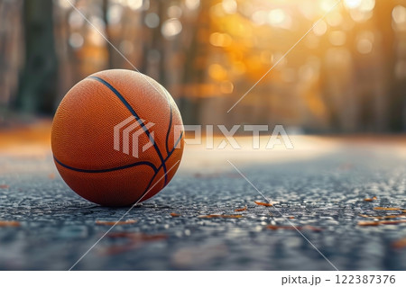 Basketball ball on outdoor court with empty space for text, sports background concept 122387376