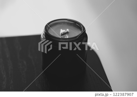 A striking black candle set within a minimalist design for an elegant and contemporary appeal A striking black candle set within a minimalist design for an elegant and contemporary appeal 122387907