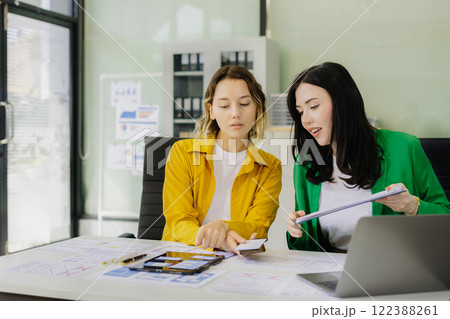 Creative digital development agency. developer team brainstorming on their project with laptop, smartphone and digital tablet. Creative digital development agency. developer team brainstorming on their project with laptop, smartphone and digital tablet. 122388261