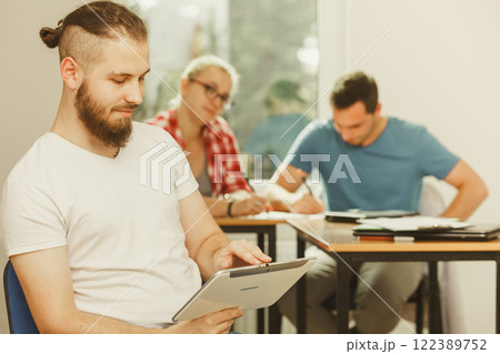 Student boy with tablet in front of her classmates 122389752