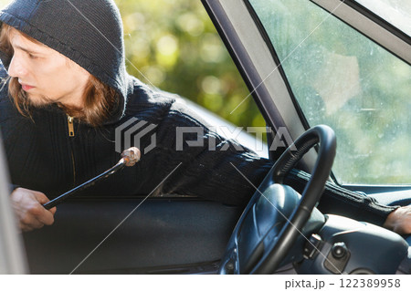 Thief burglar breaking into car Thief burglar breaking into car 122389958