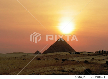 Sunset on the Giza plateau, with the pyramids in the background 122390621