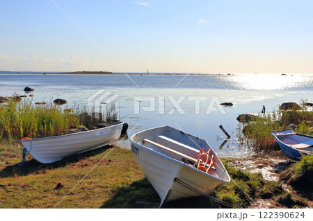 An old wooden pier with fishing boats 122390624