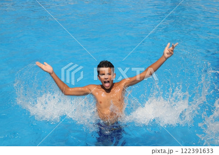 boy teenager splashing water open arms pool 122391633