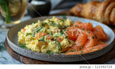 Luxurious brunch: creamy scrambled eggs with smoked salmon flakes and fresh dill on fine china. Luxurious brunch: creamy scrambled eggs with smoked salmon flakes and fresh dill on fine china. 122392729