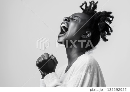 Black woman expressing powerful emotions in a dynamic pose against a solid background Black woman expressing powerful emotions in a dynamic pose against a solid background 122392925