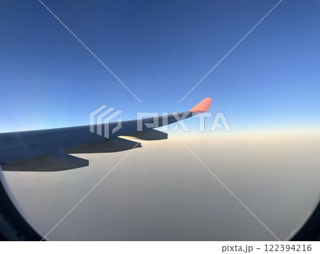 A beautiful aerial view seen from an airplane window during an exciting flight journey A beautiful aerial view seen from an airplane window during an exciting flight journey 122394216