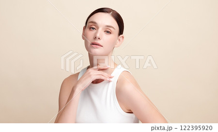 Beautiful young woman with clean fresh skin on beige background, Face care, Facial treatment, Cosmetology, beauty and spa, women portrait. Beautiful young woman with clean fresh skin on beige background, Face care, Facial treatment, Cosmetology, beauty and spa, women portrait. 122395920