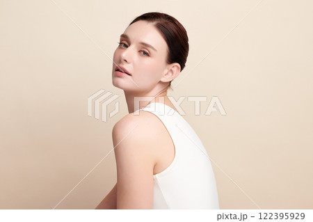 Beautiful young woman with clean fresh skin on beige background, Face care, Facial treatment, Cosmetology, beauty and spa, women portrait. Beautiful young woman with clean fresh skin on beige background, Face care, Facial treatment, Cosmetology, beauty and spa, women portrait. 122395929