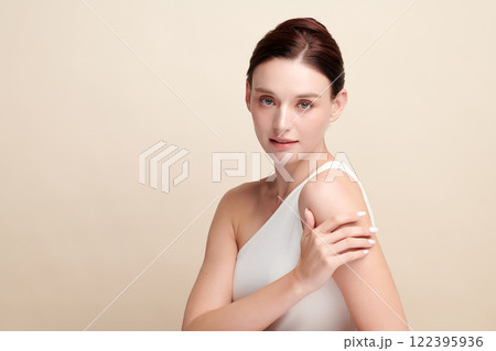 Beautiful young woman with clean fresh skin on beige background, Face care, Facial treatment, Cosmetology, beauty and spa, women portrait. Beautiful young woman with clean fresh skin on beige background, Face care, Facial treatment, Cosmetology, beauty and spa, women portrait. 122395936