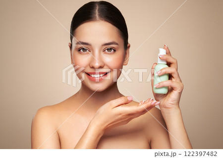 Beautiful woman with bottle of moisturizer cream Beautiful woman with bottle of moisturizer cream 122397482