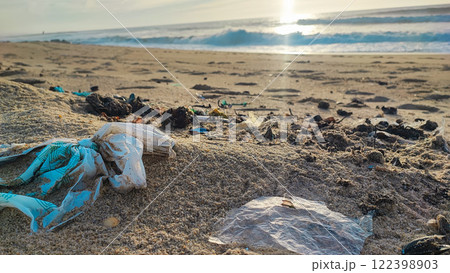 Garbage, plastic, and wastes on the beach of Portugal. Sand beaches polluted with pieces of plastic, cigarette pack Garbage, plastic, and wastes on the beach of Portugal. Sand beaches polluted with pieces of plastic, cigarette pack 122398903