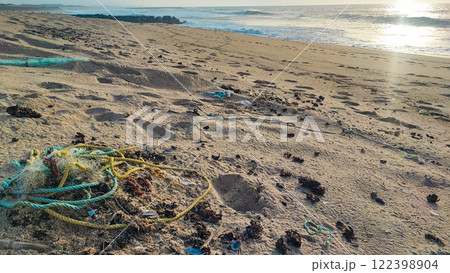 Garbage, plastic, and wastes on the beach of Portugal. Sand beaches polluted with pieces of plastic, cigarette pack Garbage, plastic, and wastes on the beach of Portugal. Sand beaches polluted with pieces of plastic, cigarette pack 122398904