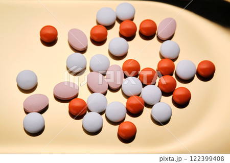 Colorful pills on a golden background. 122399408