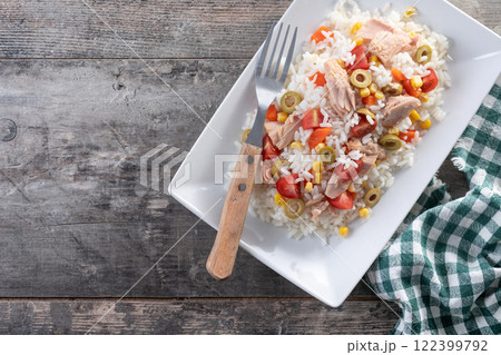 Rice salad with tomato, corn,olives and tuna on wooden table Rice salad with tomato, corn,olives and tuna on wooden table 122399792