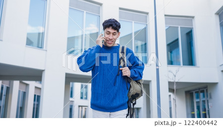 University student talking on smartphone walking in university campus University student talking on smartphone walking in university campus 122400442
