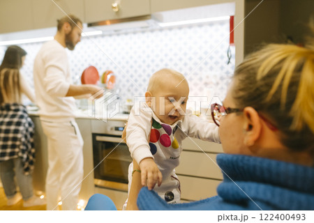 Enjoying beautiful family bonding moments in a cozy, inviting kitchen atmosphere 122400493