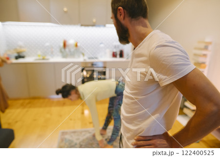 A couple joyfully interacts in their modern kitchen, highlighting their love for cooking A couple joyfully interacts in their modern kitchen, highlighting their love for cooking 122400525