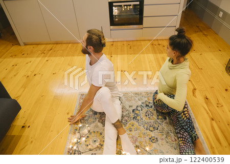 A Beautiful Couple Practicing Yoga Together in a Cozy and Inviting Space at Home A Beautiful Couple Practicing Yoga Together in a Cozy and Inviting Space at Home 122400539