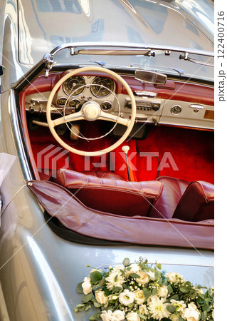 Old vintage convertible car at a wedding church in Antibes, France Old vintage convertible car at a wedding church in Antibes, France 122400716