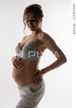 Beautiful pregnant woman in lingerie showcasing her baby bump 122401560