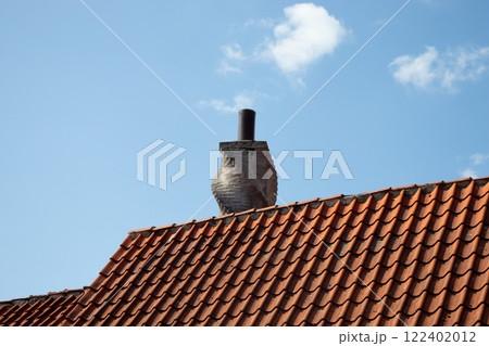 Chimney on the roof of an old houses. Chimney on the roof of an old houses. 122402012