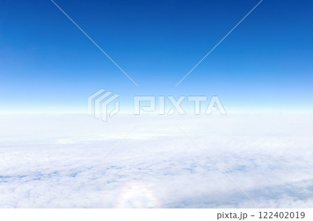 View from airplane window of blue sky with clouds 122402019