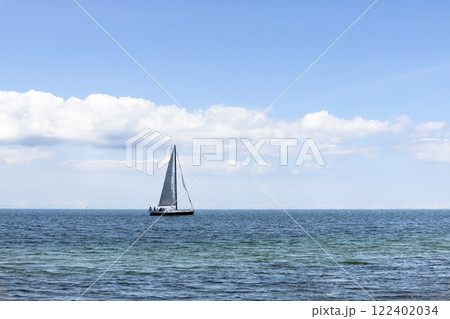 Beautiful seascape. Sailboat floats on the blue sea. Beautiful seascape. Sailboat floats on the blue sea. 122402034