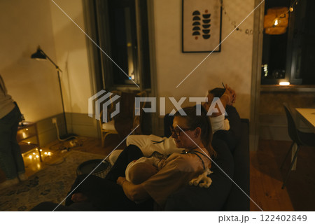 Enjoying a Cozy Evening with Family and Newborn in a Stylishly Designed Living Room Enjoying a Cozy Evening with Family and Newborn in a Stylishly Designed Living Room 122402849