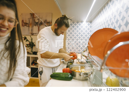 A Loving Couple Engaged in Cooking Together in a Modern, Stylish Kitchen Environment A Loving Couple Engaged in Cooking Together in a Modern, Stylish Kitchen Environment 122402900