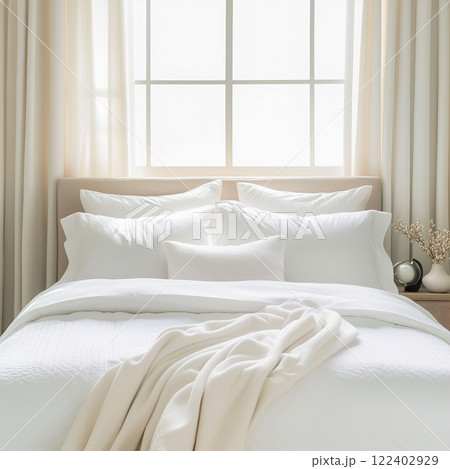 Bright white home bedroom interior, clean fresh white bed linen and pillows on bed, cozy morning room decor 122402929