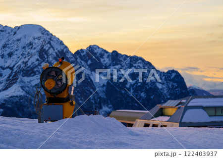 Snow cannon or gun snowing slopes or mountain for skiers and snowboarders, artificial snow Snow cannon or gun snowing slopes or mountain for skiers and snowboarders, artificial snow 122403937