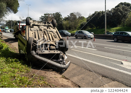 Damaged wrecked car after accident lying upside Damaged wrecked car after accident lying upside 122404424