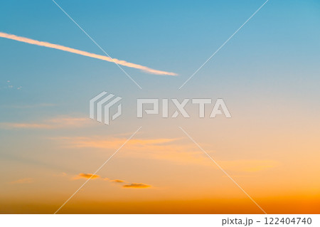 夕焼け空に浮かぶ飛行機雲　a-3 青味 122404740