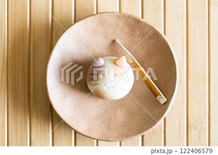 A piece of delicious Japanese confectionery on ceramic plate on wooden table. 122406579
